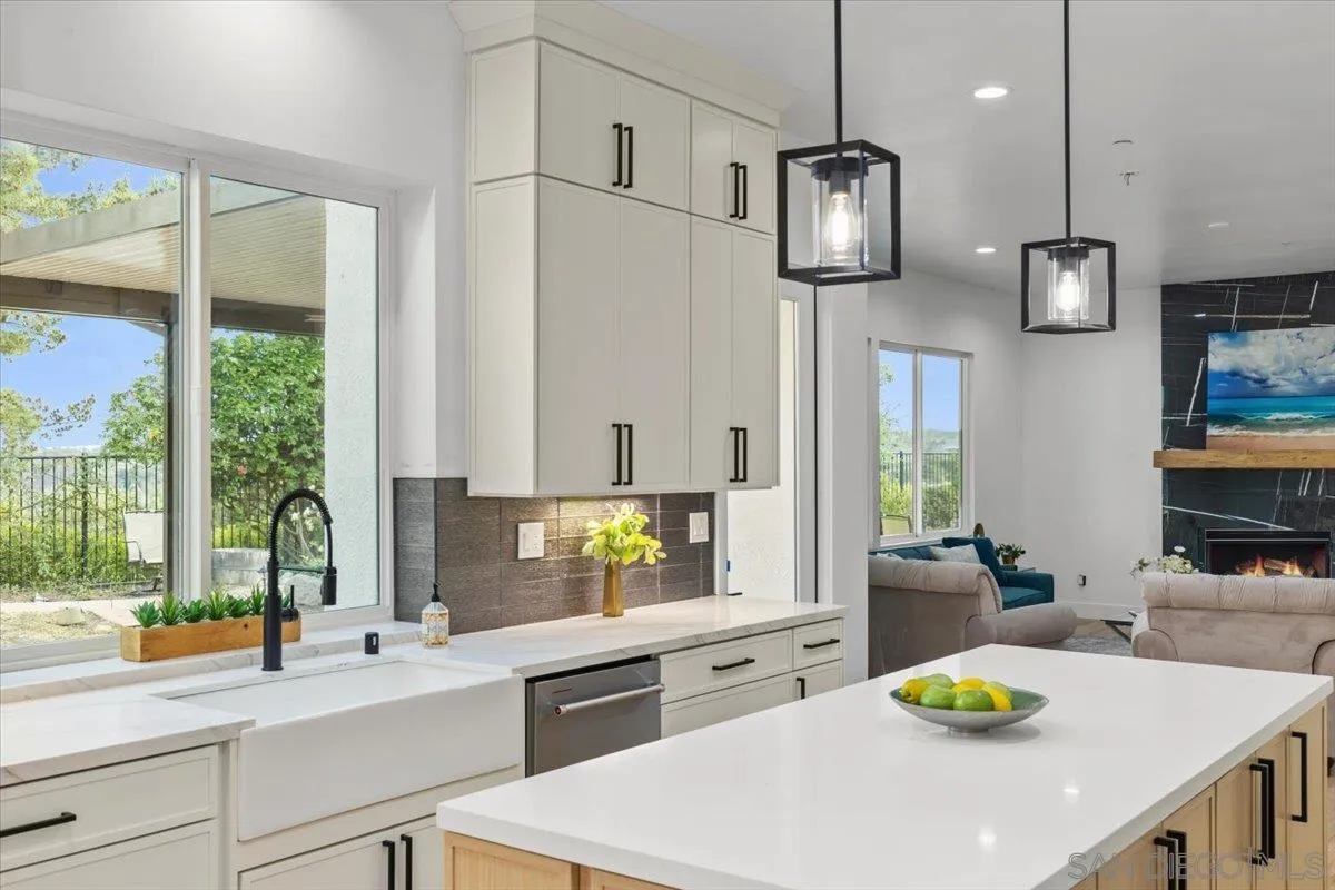 2196 Kirkcaldy Road Fallbrook, CA 92028 - Photo 11 of 57 a kitchen with a sink a counter top space and a wooden floor