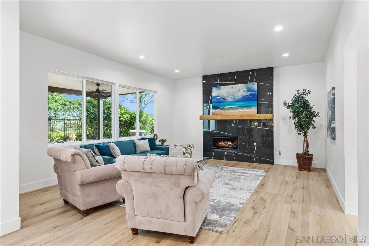 2196 Kirkcaldy Road Fallbrook, CA 92028 - Photo 13 of 57 a living room with furniture a fireplace and a flat screen tv