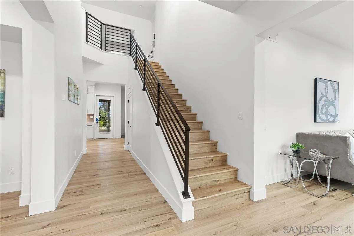 2196 Kirkcaldy Road Fallbrook, CA 92028 - Photo 23 of 57 a view of a hallway with wooden floor and stairs