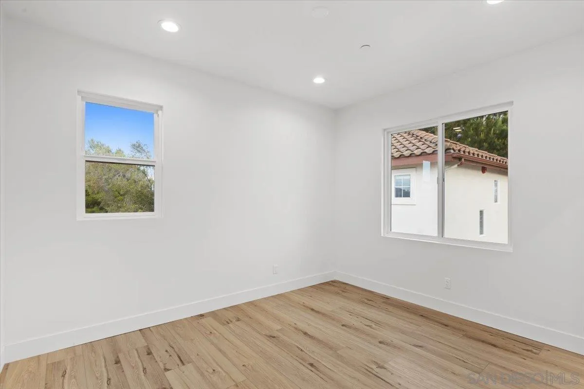 2196 Kirkcaldy Road Fallbrook, CA 92028 - Photo 31 of 57 an empty room with wooden floor and windows