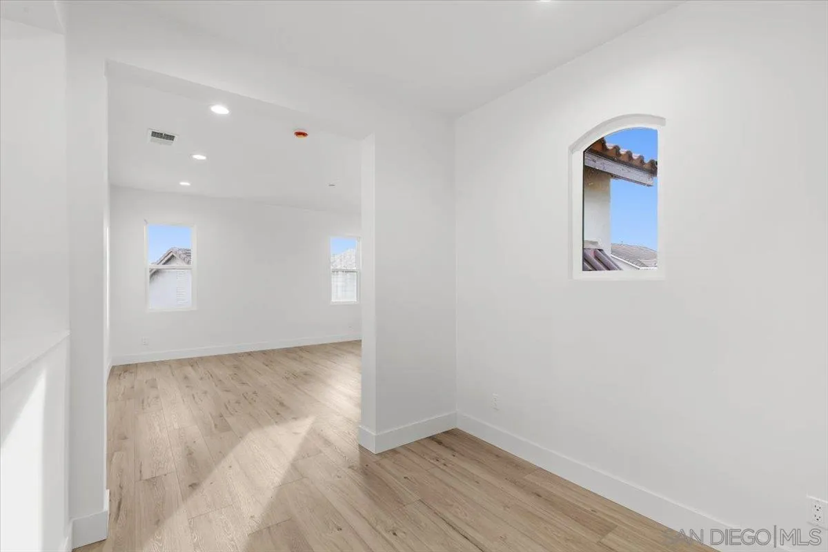 2196 Kirkcaldy Road Fallbrook, CA 92028 - Photo 33 of 57 an empty room with wooden floor and a window