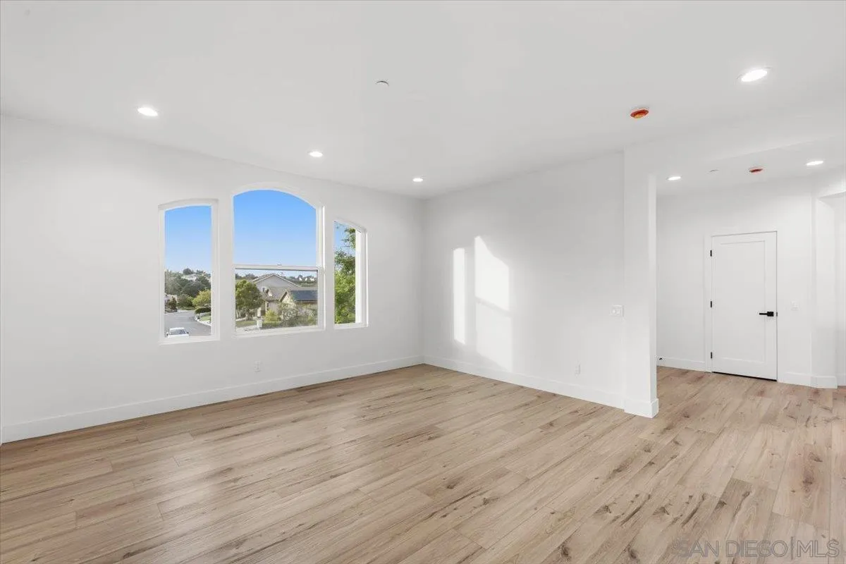 2196 Kirkcaldy Road Fallbrook, CA 92028 - Photo 35 of 57 an empty room with wooden floor and a window