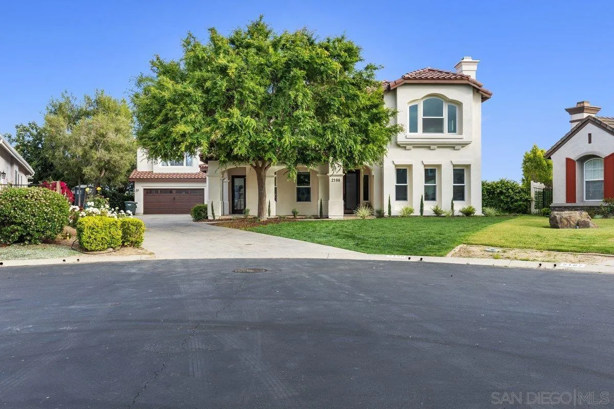 2196 Kirkcaldy Road Fallbrook, CA 92028 - Photo 4 of 57 a front view of a house with a garden and trees