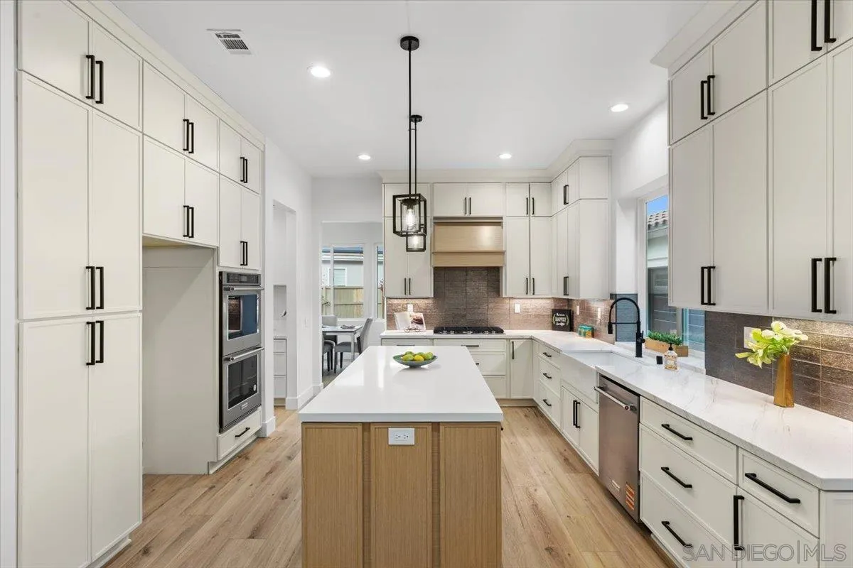 2196 Kirkcaldy Road Fallbrook, CA 92028 - Photo 7 of 57 a view of a kitchen with kitchen island a sink stainless steel appliances and cabinets