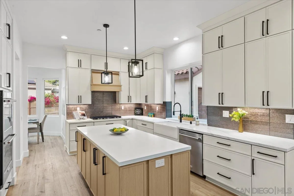 2196 Kirkcaldy Road Fallbrook, CA 92028 - Photo 9 of 57 a kitchen that has a lot of cabinets in it with wooden floor and white appliances