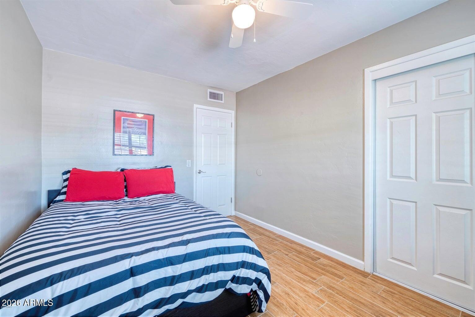 3415 East Camelback Road Phoenix, AZ 85018 - Photo 9 of 25 a bedroom with a bed and a painting on the wall