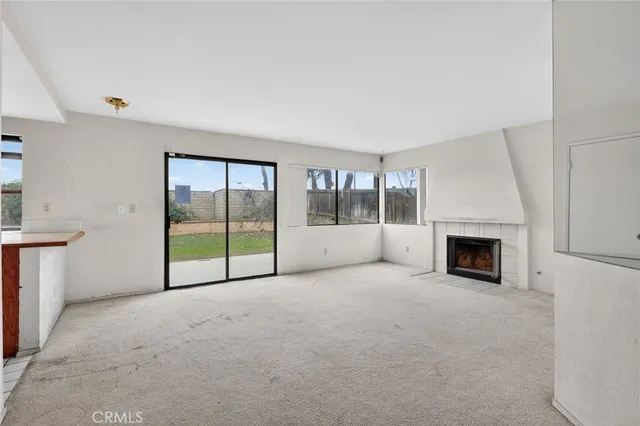 an empty room with floor to ceiling window and an empty room