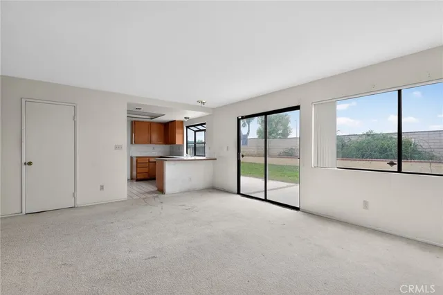 a view of a big room with windows and an empty room