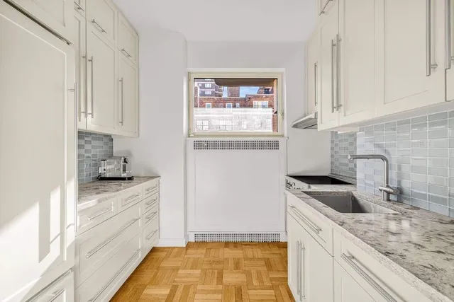 a bathroom with a granite countertop sink a toilet a shower and a mirror