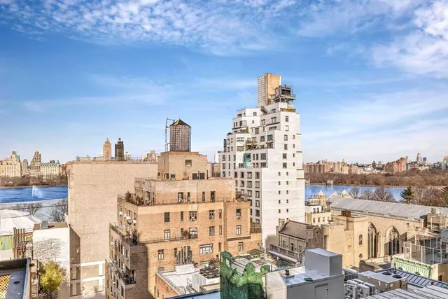 a kitchen with granite countertop a sink a stove top oven and cabinetry
