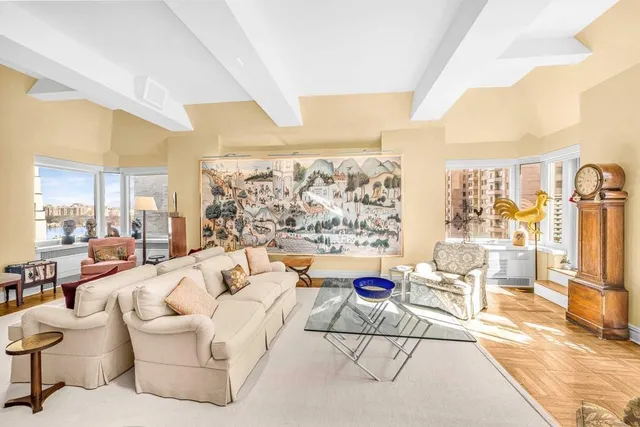 a living room with furniture and a floor to ceiling window
