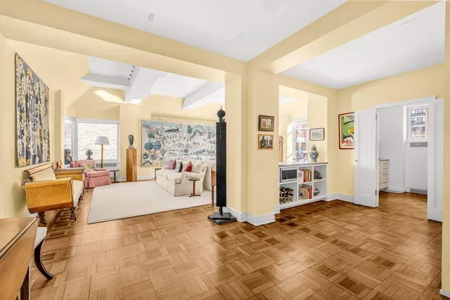 a living room with furniture large window and a table