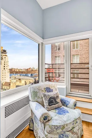 a bedroom with furniture and large windows
