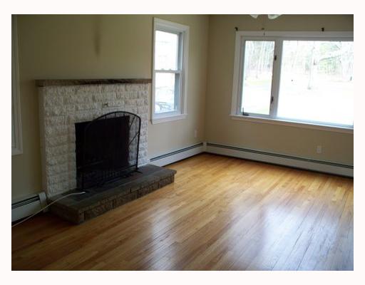 303 Angell Road Lincoln, RI 02865 - Photo 4 of 9 Living Room. Beautiful white brick fireplace graces the formal living room, outstanding view from pichure window.