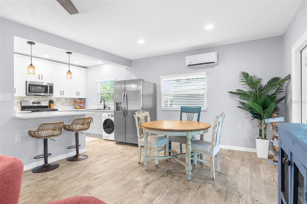 5421 Gay Street Weeki Wachee, FL 34607 - Photo 15 of 55 a room with dining table and chairs