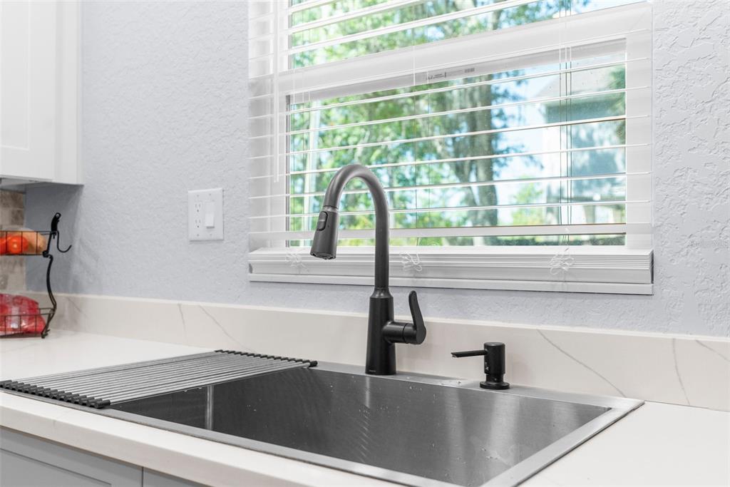 5421 Gay Street Weeki Wachee, FL 34607 - Photo 17 of 55 a kitchen with a sink and a window