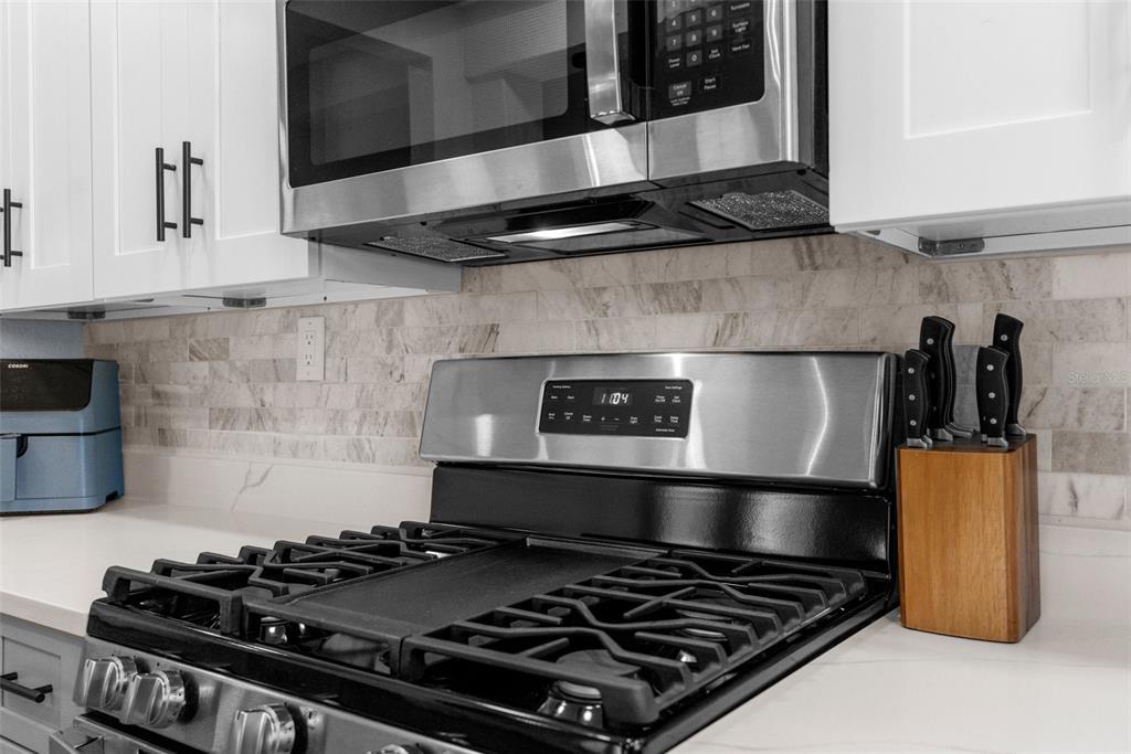 5421 Gay Street Weeki Wachee, FL 34607 - Photo 18 of 55 a stove top oven sitting inside of a kitchen