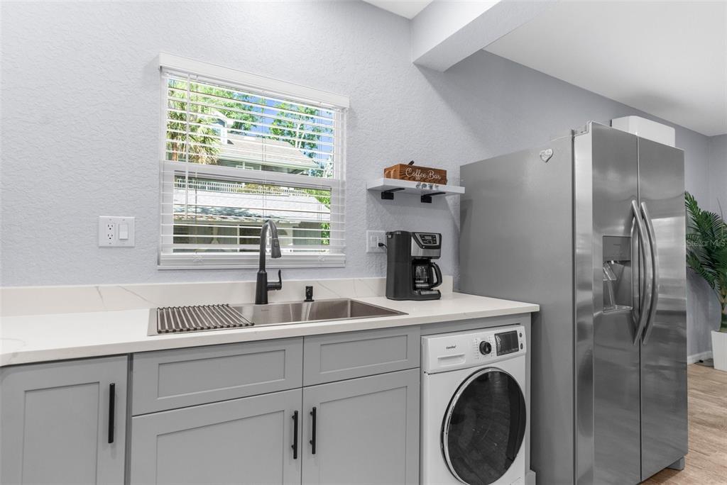 5421 Gay Street Weeki Wachee, FL 34607 - Photo 21 of 55 a utility room with sink dryer and washer