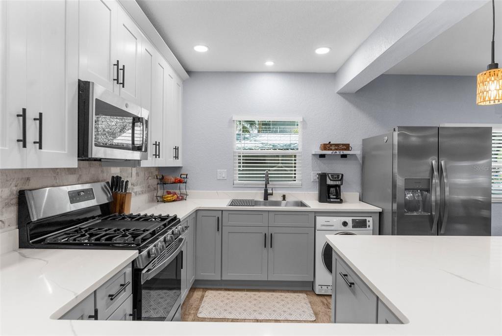 5421 Gay Street Weeki Wachee, FL 34607 - Photo 23 of 55 a kitchen with a stove a sink and a refrigerator