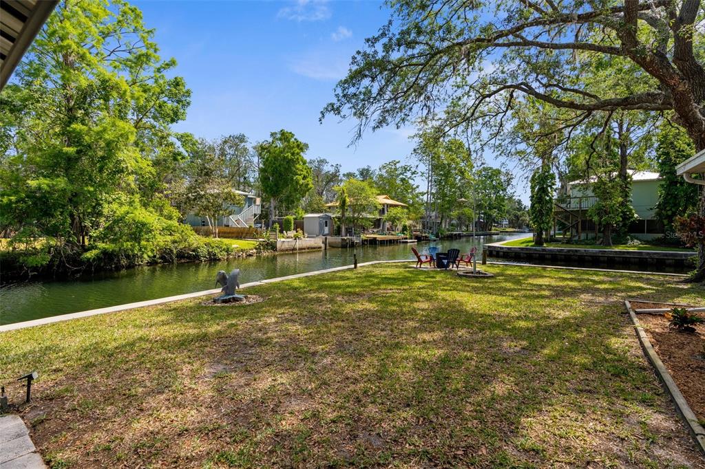 5421 Gay Street Weeki Wachee, FL 34607 - Photo 37 of 55 a view of a lake with a bench