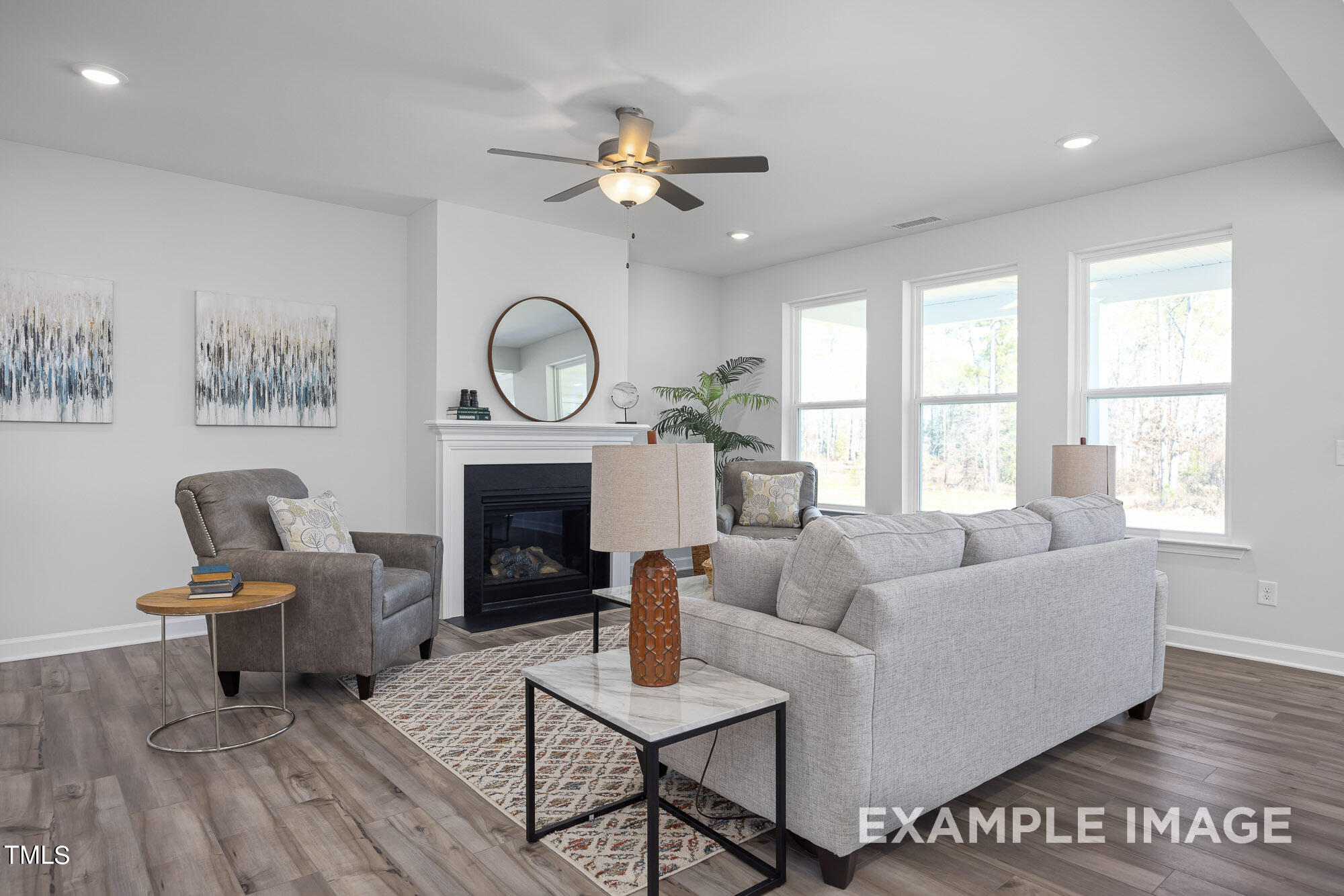 62 Golden Leaf Farms Road Angier, NC 27501 - Photo 14 of 31 a living room with furniture a fireplace and a large window