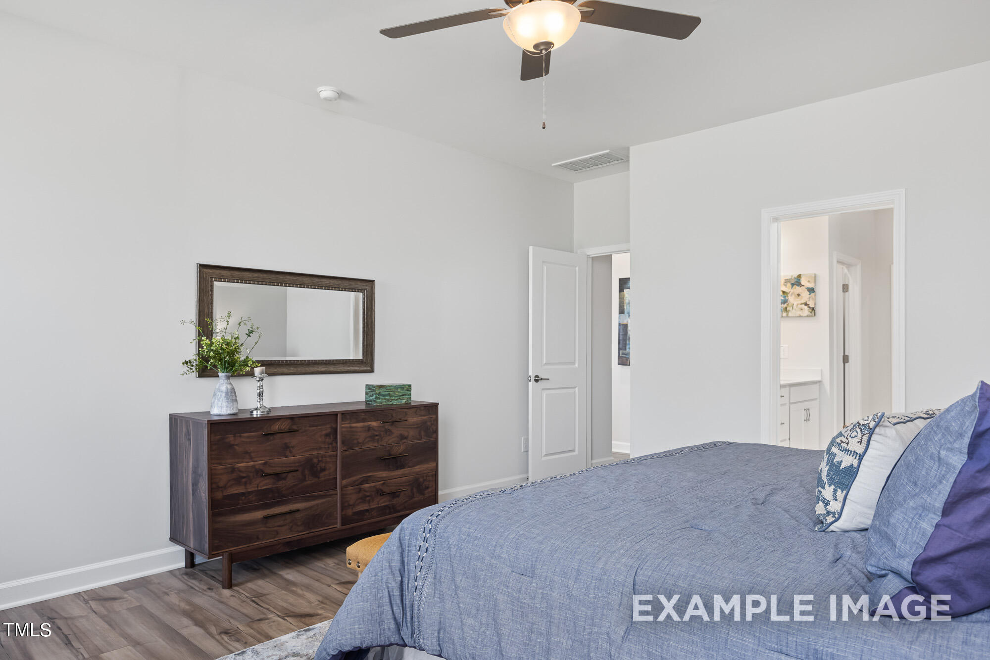 62 Golden Leaf Farms Road Angier, NC 27501 - Photo 19 of 31 a bedroom with a bed and a dresser