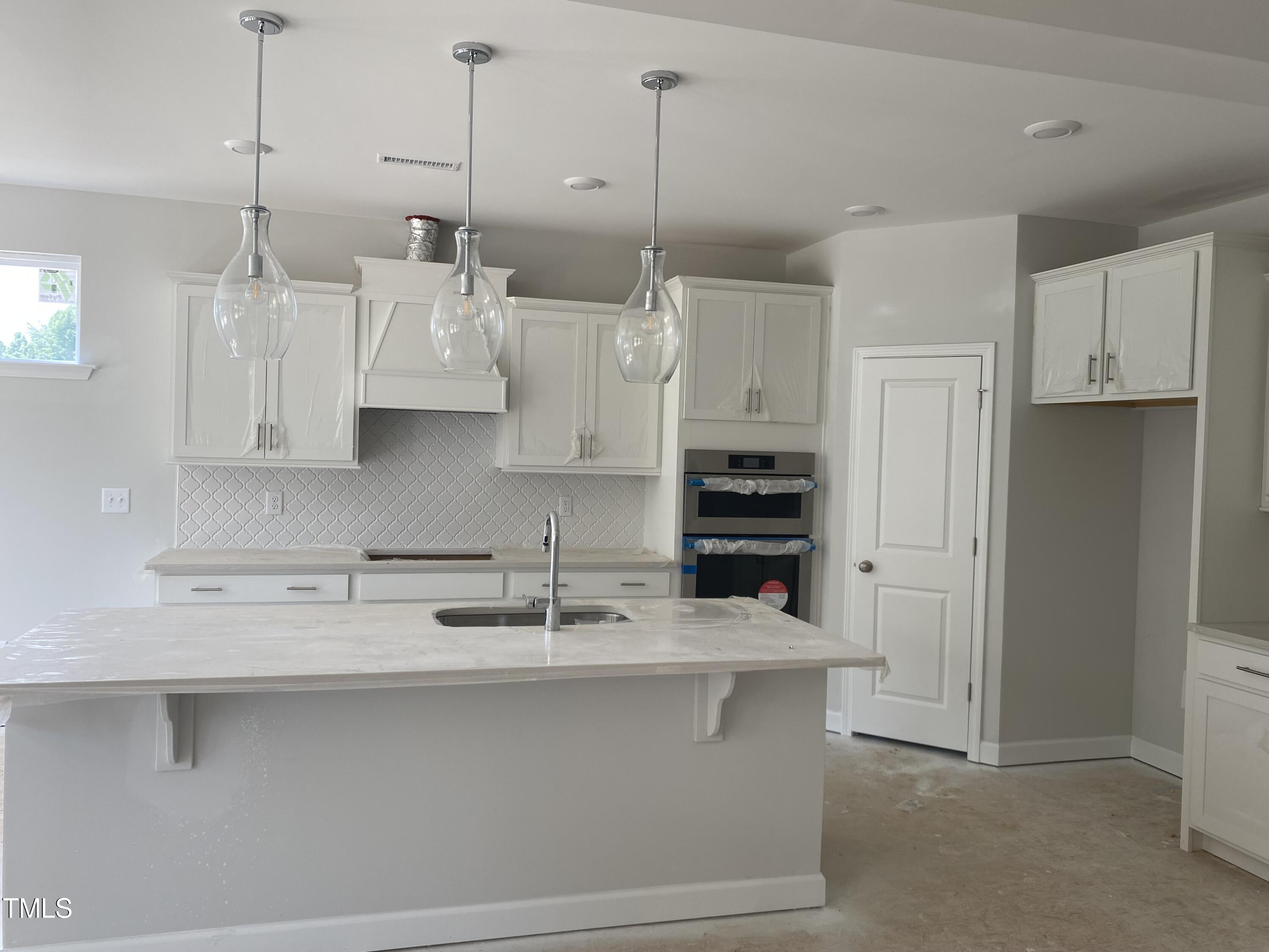 62 Golden Leaf Farms Road Angier, NC 27501 - Photo 5 of 31 a kitchen with stainless steel appliances granite countertop a sink a window and white cabinets