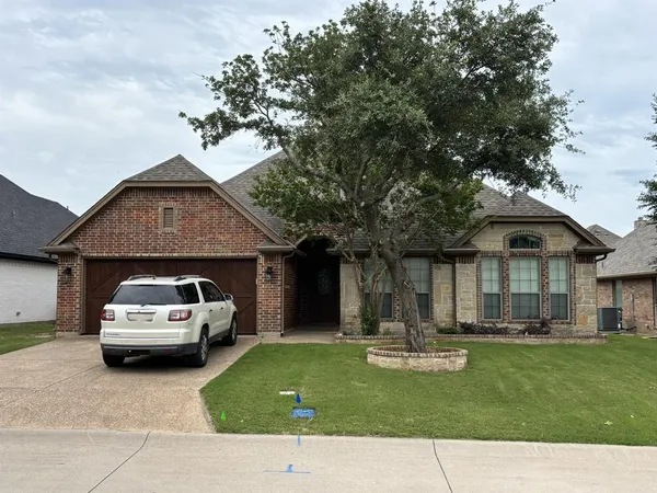 a view of a car parked in front of a house