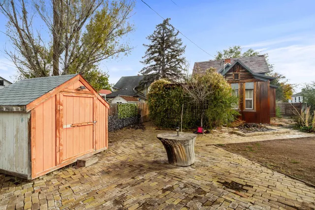 a backyard of a house with table and chairs