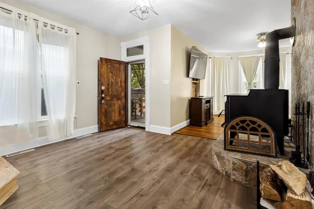 a view of a livingroom with wooden floor and a window