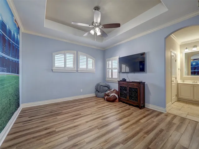 a living room with furniture and a ceiling fan