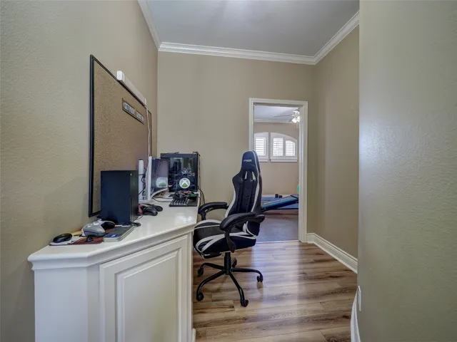 a dining hall with stainless steel appliances granite countertop a stove a refrigerator a oven a sink with a dining table and chairs with wooden floor