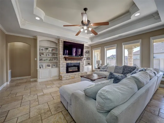 a living room with furniture and a chandelier