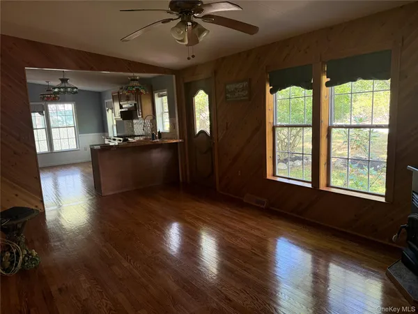a view of entryway with a window and wooden floor