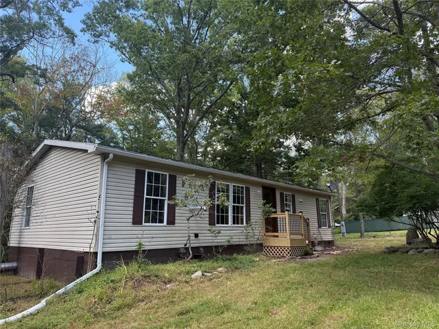 a front view of a house with a yard glass top table and chairs