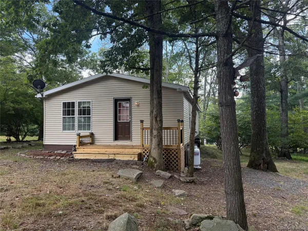 a house with a yard and large trees