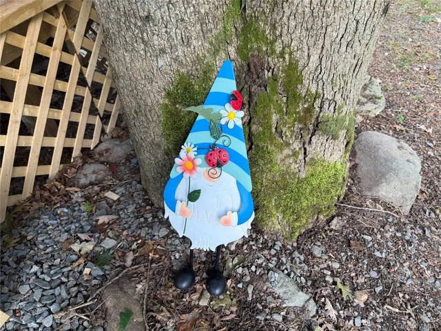 a dining room with wooden floor a chandelier a potted plant and a chandelier