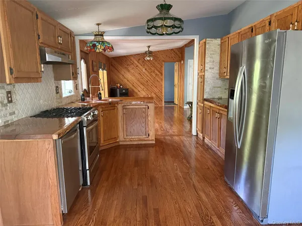 a kitchen with refrigerator and window