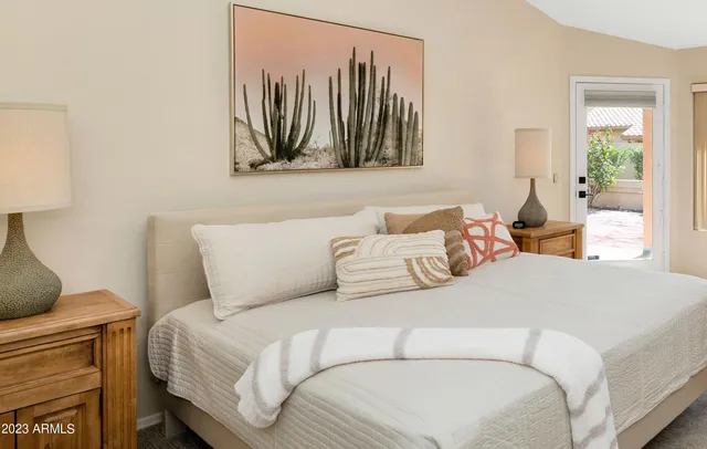 a bedroom with a bed and a painting on the wall