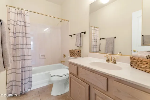 a bathroom with a sink toilet vanity and shower