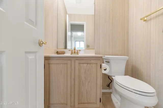 a bathroom with a toilet a sink and mirror