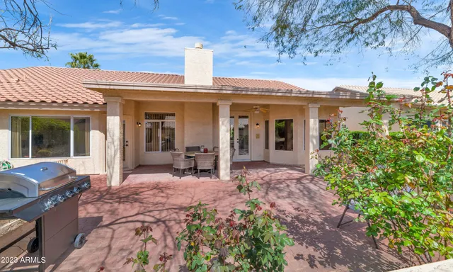 a view of a house with backyard sitting area and garden