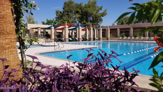 a view of a house with swimming pool and sitting area