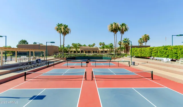 a outdoor space with pool and table and chairs