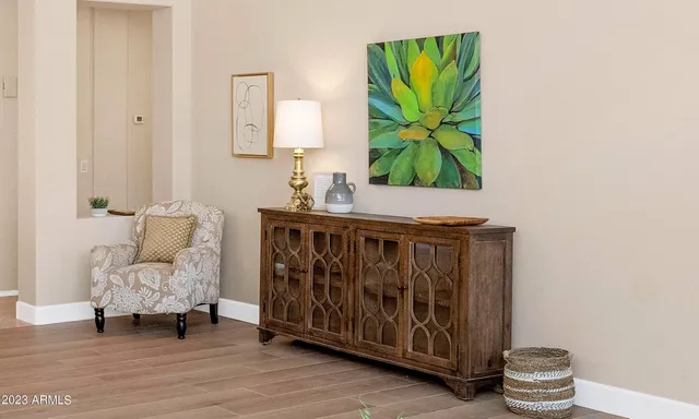 a living room with furniture and painting on the wall