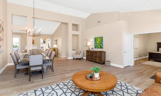 a living room with furniture and a dining table