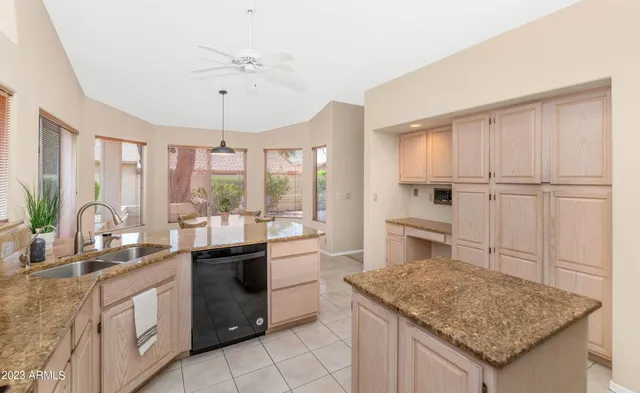 a kitchen with a sink refrigerator and cabinets