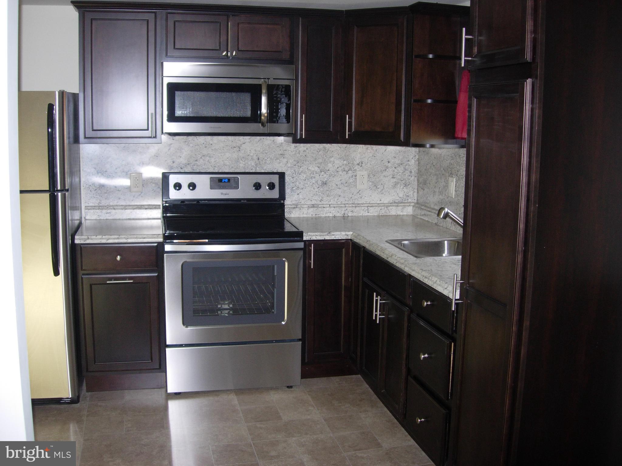 108 South Kenhorst Boulevard Reading, PA 19607 - Photo 2 of 30 a kitchen with a stove and a refrigerator