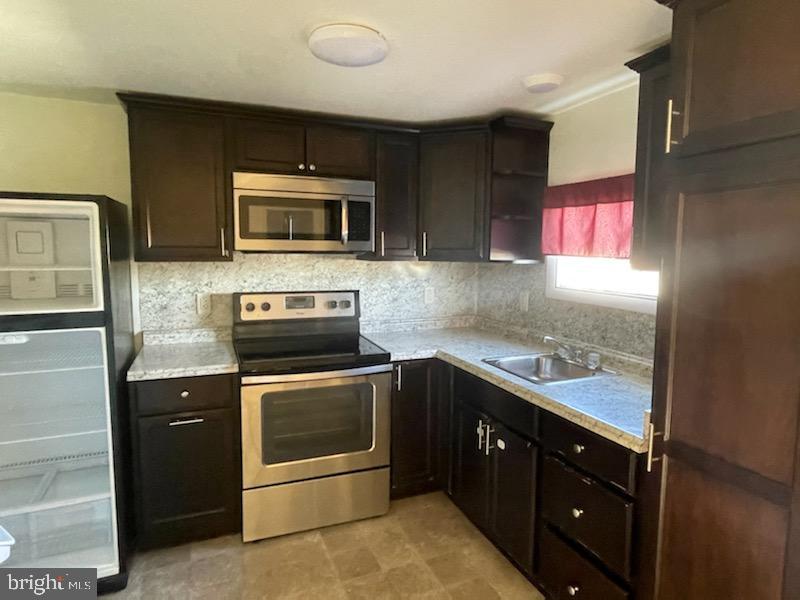 108 South Kenhorst Boulevard Reading, PA 19607 - Photo 3 of 30 a kitchen with a stove microwave and sink