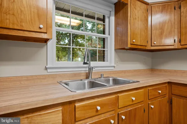 a kitchen with granite countertop sink and cabinets